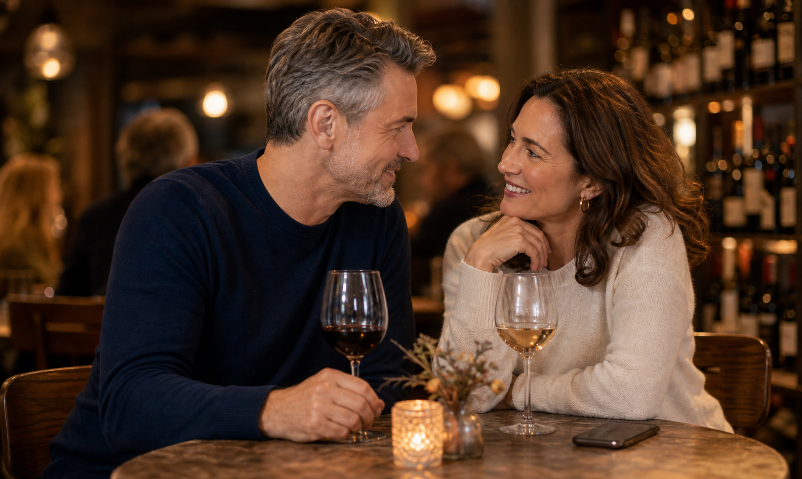 Mature adults having a warm first date conversation in a cozy wine bar